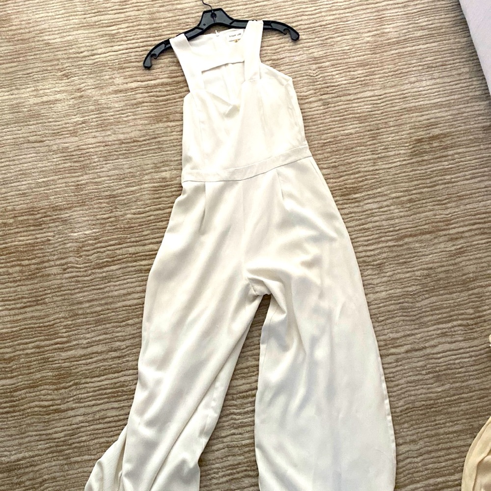 White jumpsuit. Perfect for a bridal shower or rehearsal dinner!